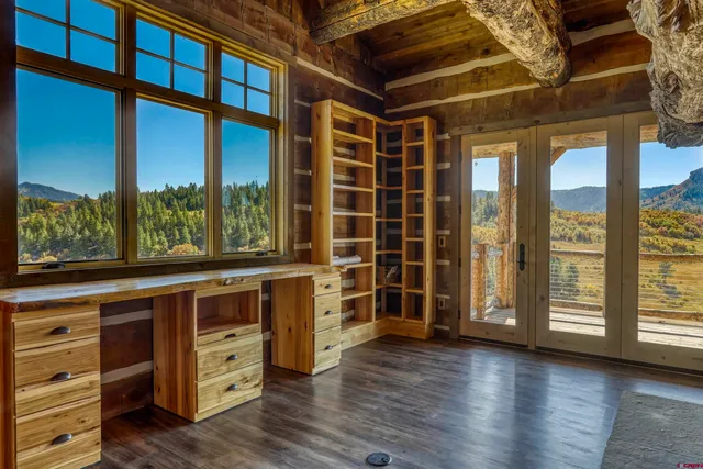 a view of an entryway with wooden floor and door