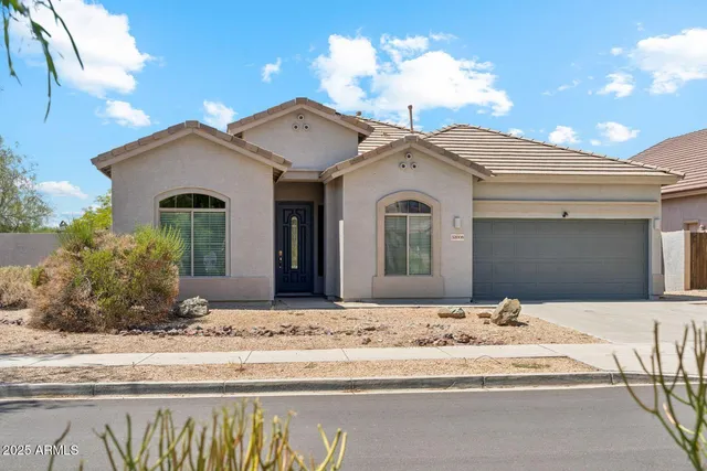 a view of a white house with a yard
