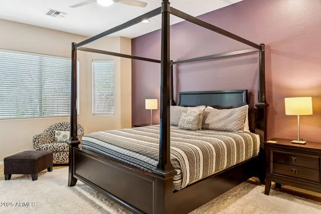 a bedroom with a bed lamp and a window