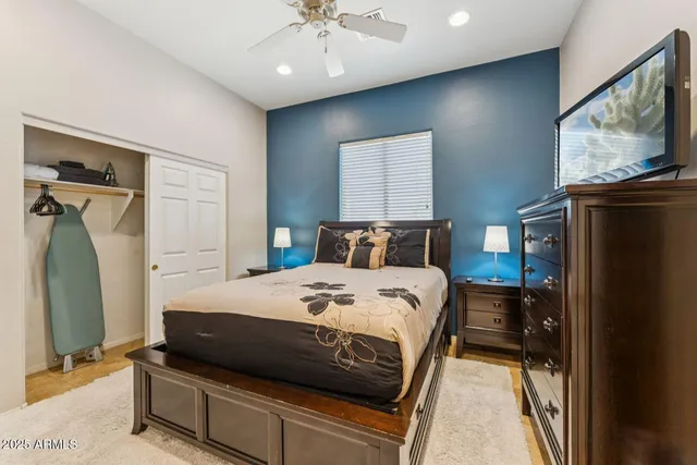 a bedroom with a bed and a flat tv screen