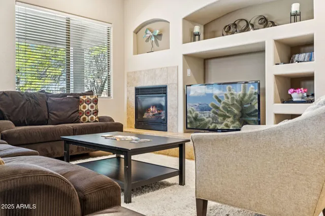 a living room with furniture and a fireplace