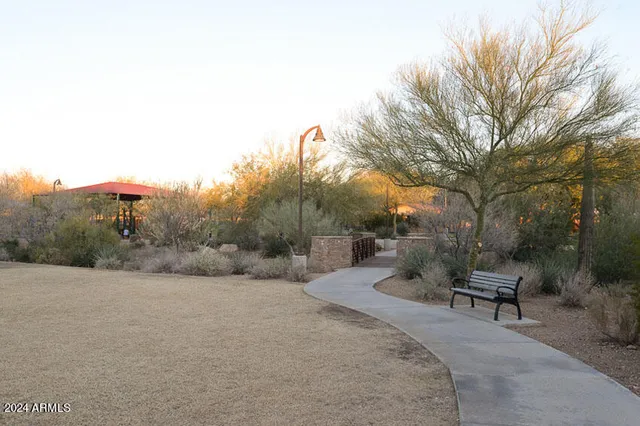a view of patio with a table and chairs and a barbeque