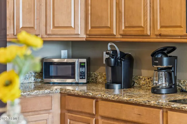 a kitchen with stainless steel appliances granite countertop a sink and cabinets