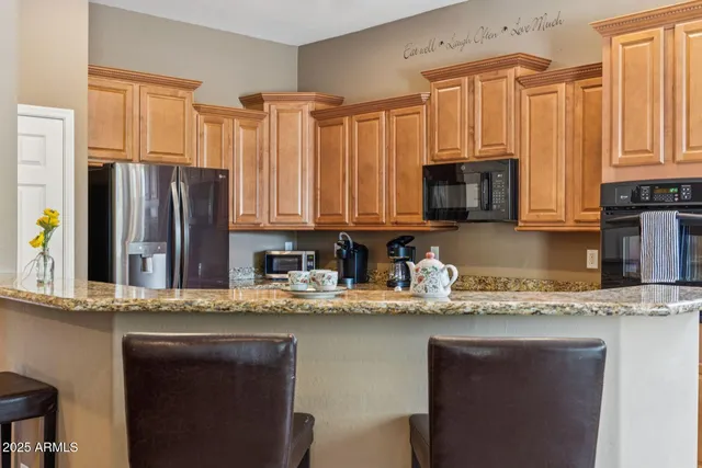 a kitchen with stainless steel appliances granite countertop a refrigerator sink and cabinets
