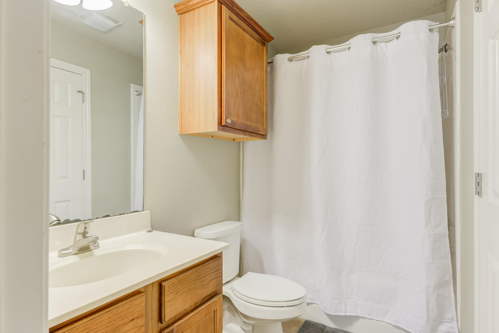 2111 Main Street, Unit 3 Lubbock, TX 79401 - Photo 11 of 49 a bathroom with a sink a toilet and shower
