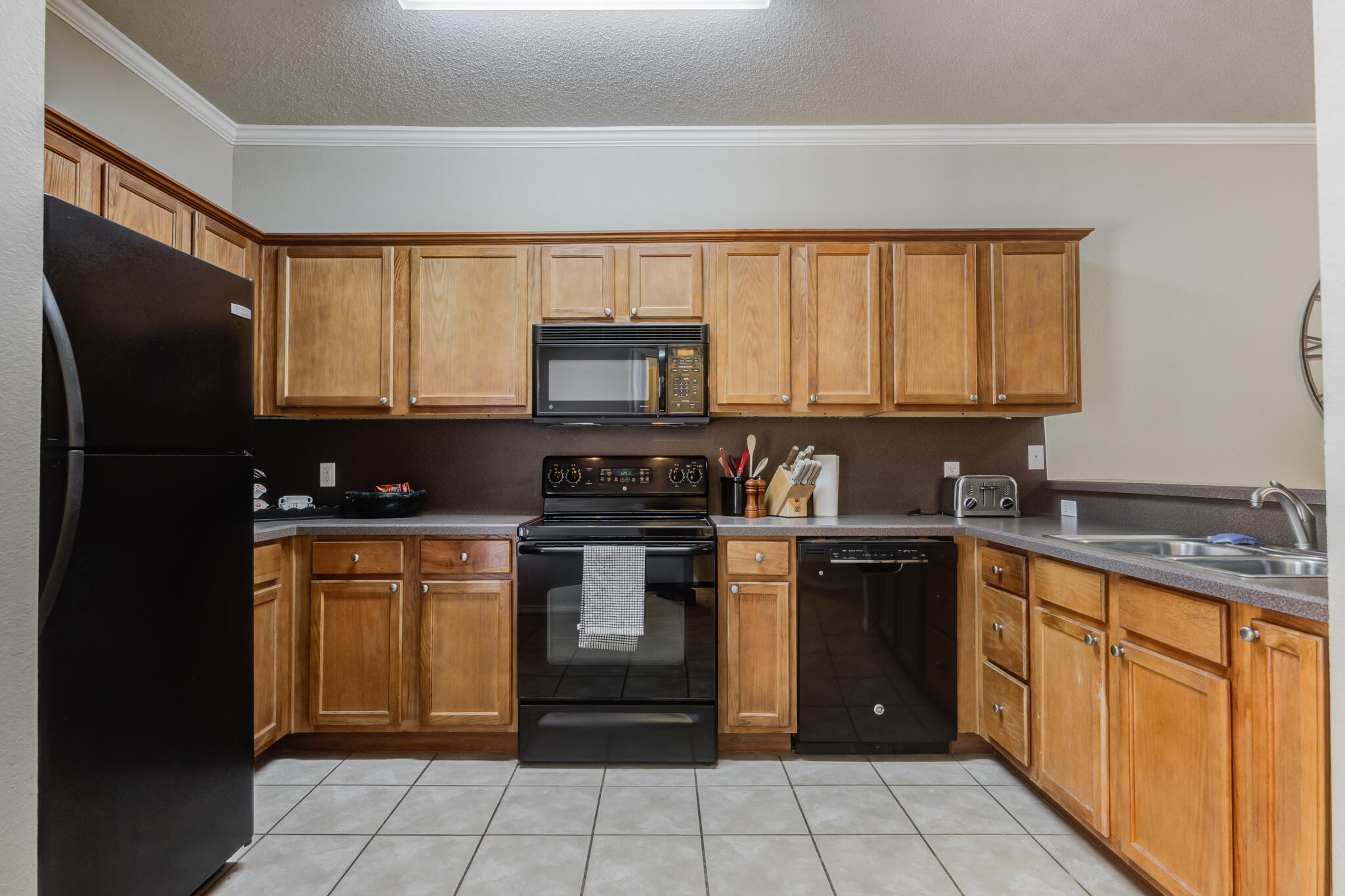 2111 Main Street, Unit 3 Lubbock, TX 79401 - Photo 15 of 49 a kitchen with stainless steel appliances granite countertop a stove a sink dishwasher and a refrigerator
