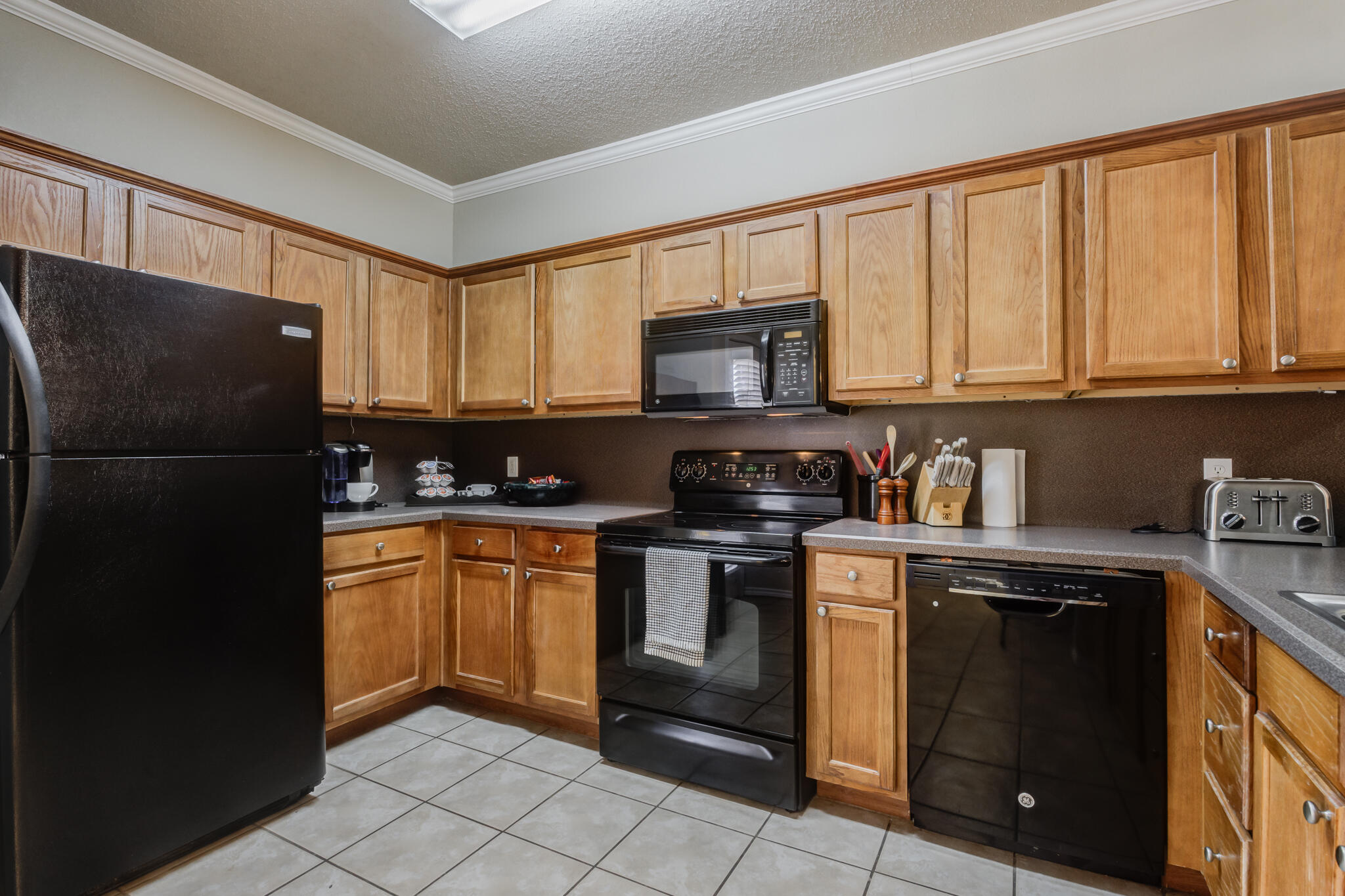 2111 Main Street, Unit 3 Lubbock, TX 79401 - Photo 16 of 49 a kitchen with stainless steel appliances granite countertop a refrigerator a stove a sink and a microwave