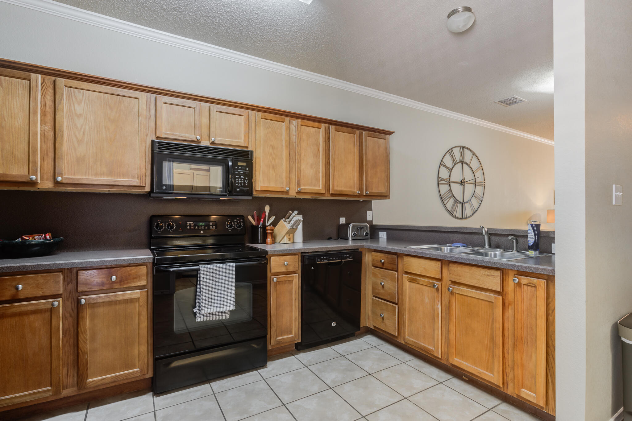 2111 Main Street, Unit 3 Lubbock, TX 79401 - Photo 17 of 49 a kitchen with stainless steel appliances granite countertop a stove a sink and a microwave