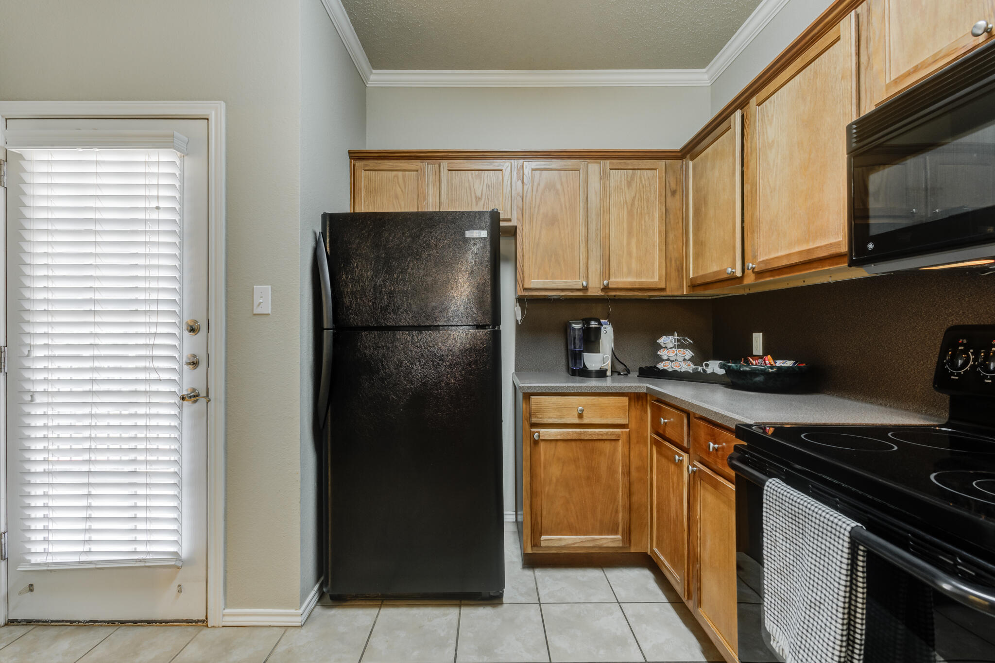 2111 Main Street, Unit 3 Lubbock, TX 79401 - Photo 19 of 49 a kitchen with stainless steel appliances granite countertop a refrigerator and a sink