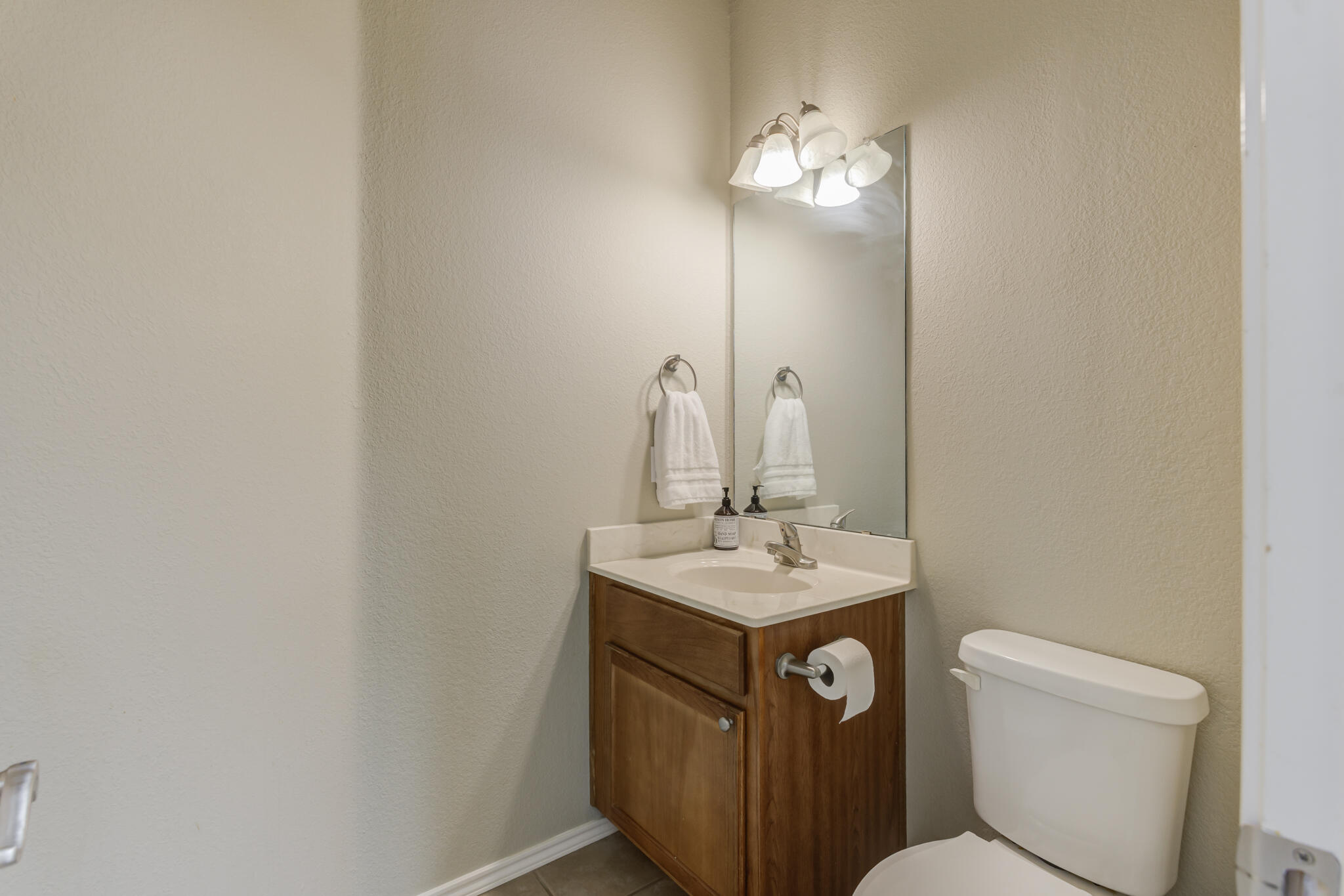 2111 Main Street, Unit 3 Lubbock, TX 79401 - Photo 21 of 49 a bathroom with a toilet sink and mirror