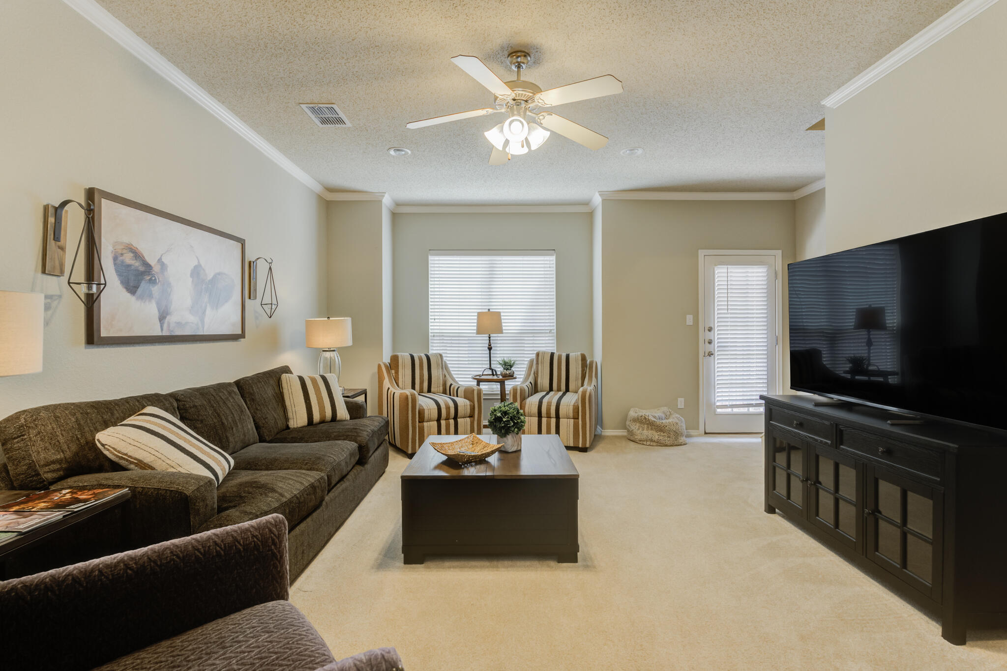 2111 Main Street, Unit 3 Lubbock, TX 79401 - Photo 22 of 49 a living room with furniture and a flat screen tv
