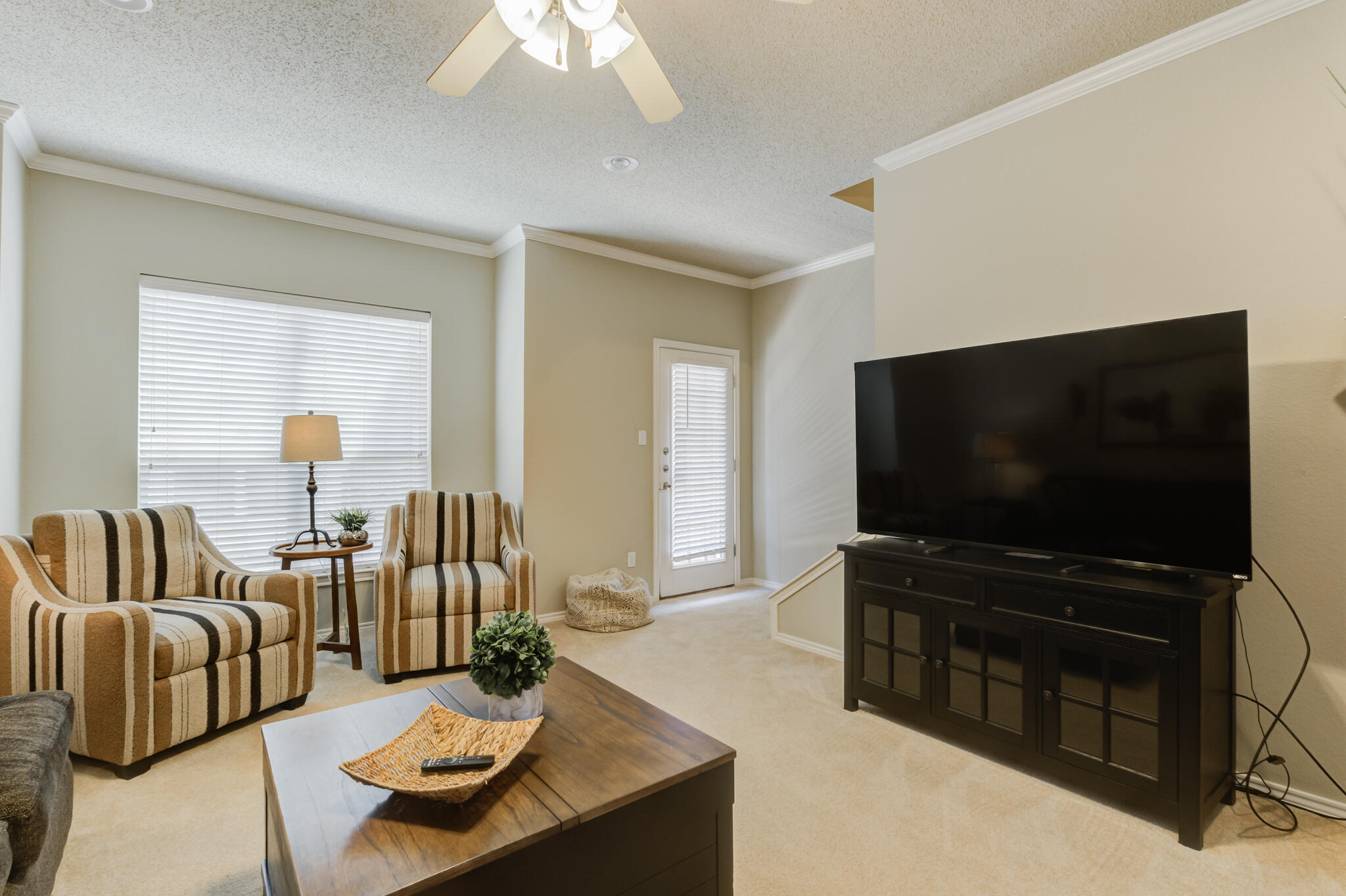 2111 Main Street, Unit 3 Lubbock, TX 79401 - Photo 27 of 49 a living room with furniture and a flat screen tv
