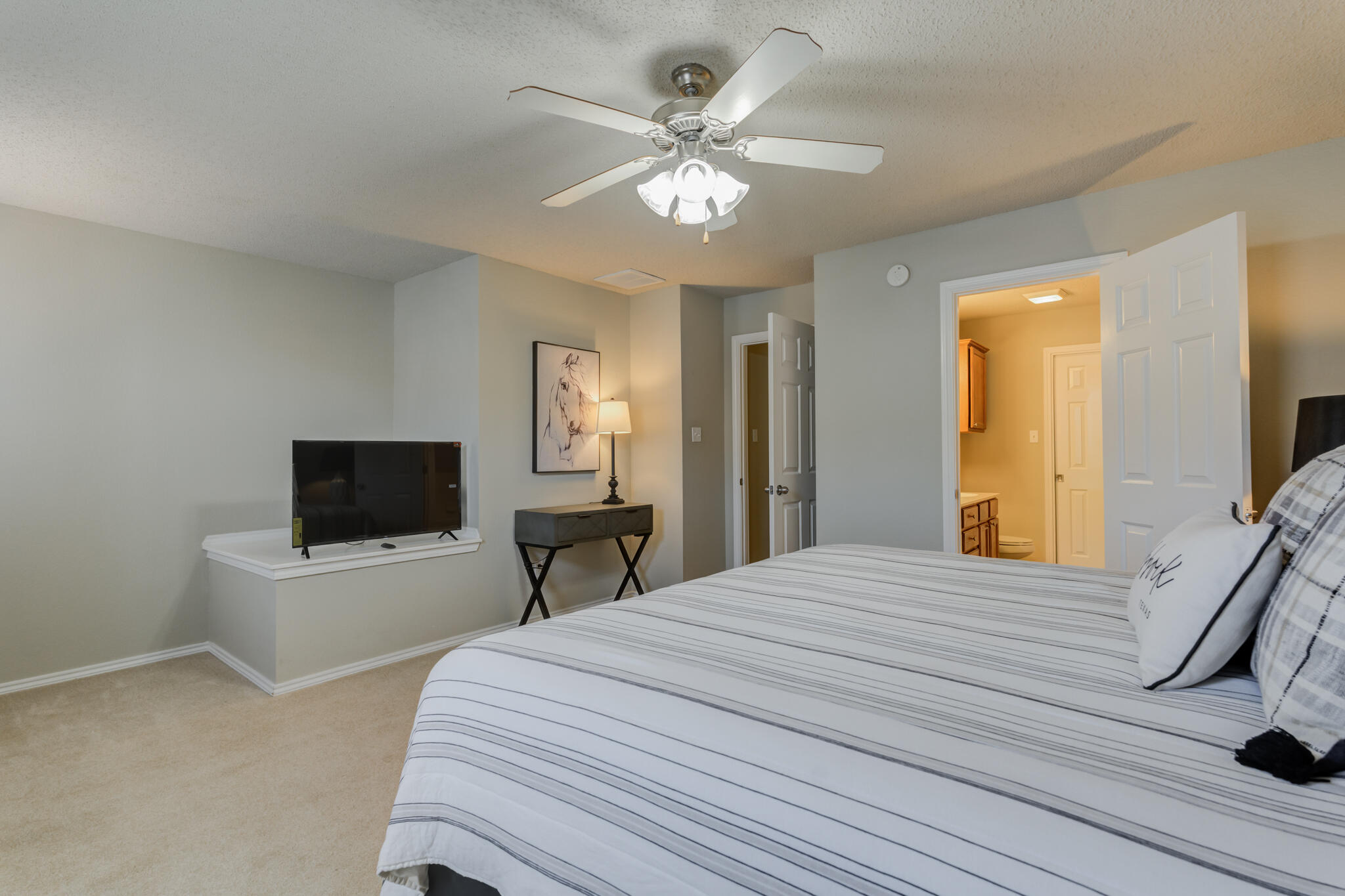 2111 Main Street, Unit 3 Lubbock, TX 79401 - Photo 31 of 49 a bedroom with a bed and a flat screen tv