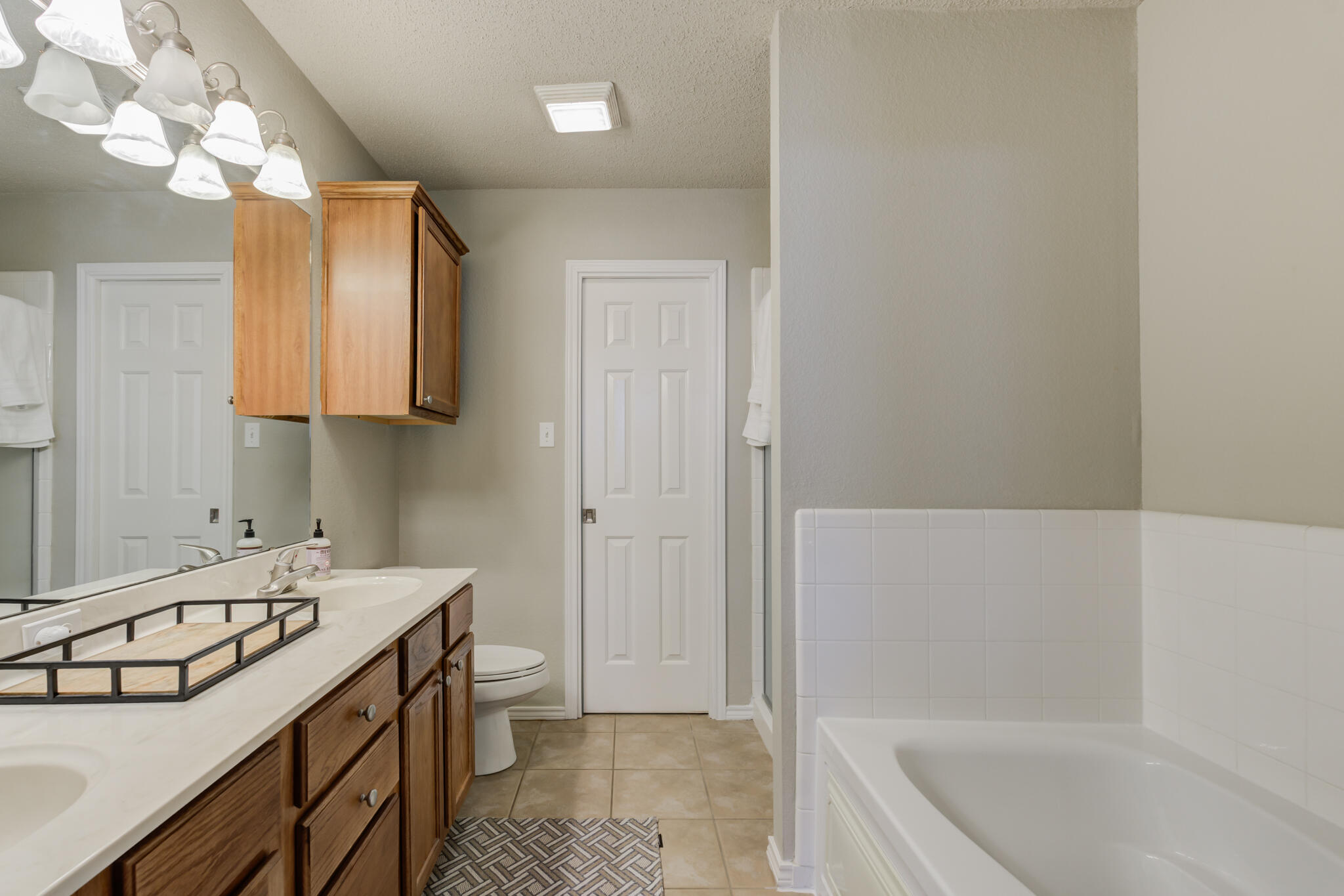 2111 Main Street, Unit 3 Lubbock, TX 79401 - Photo 32 of 49 a bathroom with a sink a toilet and shower