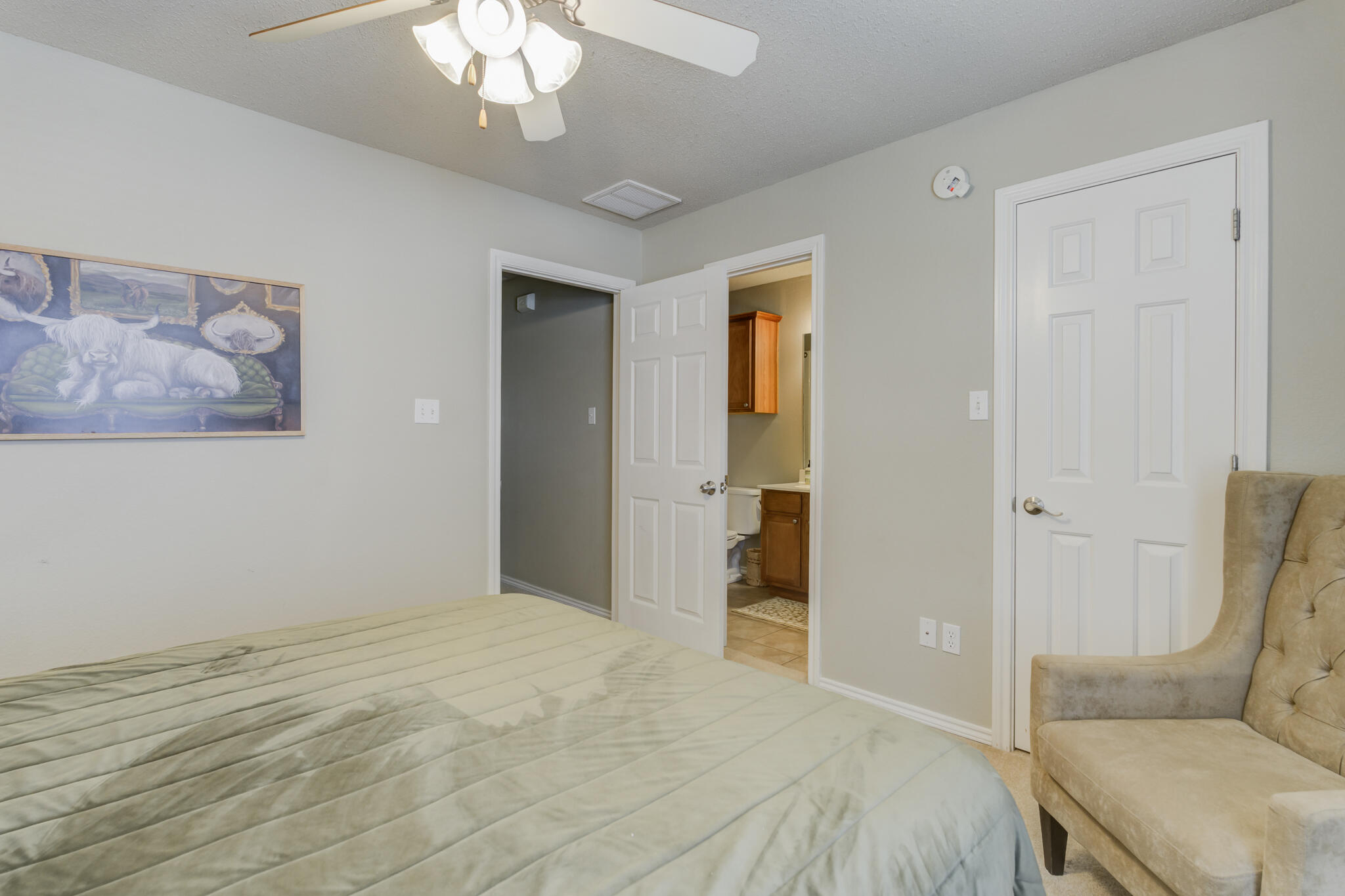 2111 Main Street, Unit 3 Lubbock, TX 79401 - Photo 40 of 49 a bedroom with a bed and a chandelier