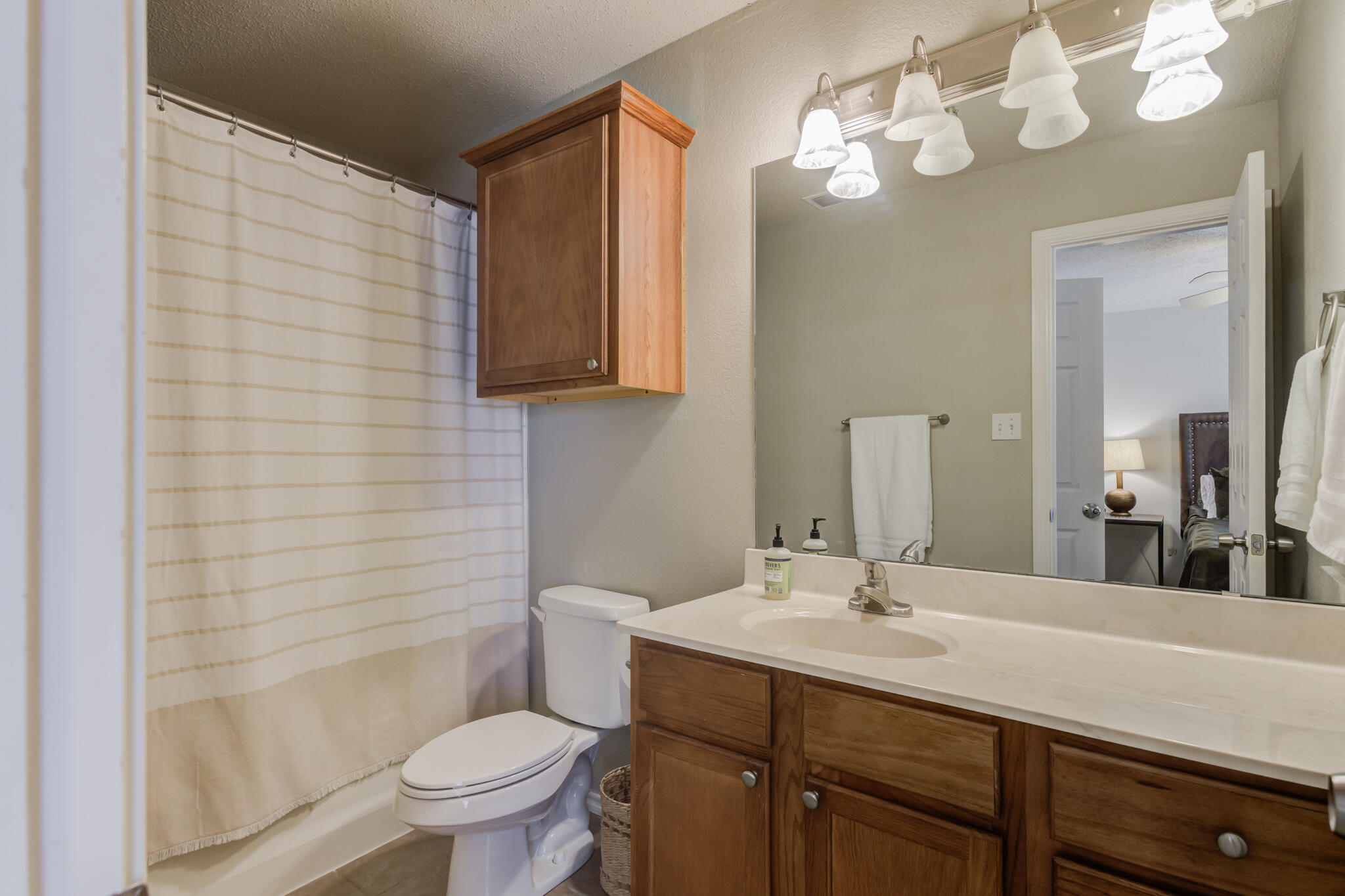 2111 Main Street, Unit 3 Lubbock, TX 79401 - Photo 41 of 49 a bathroom with a sink a toilet and a mirror