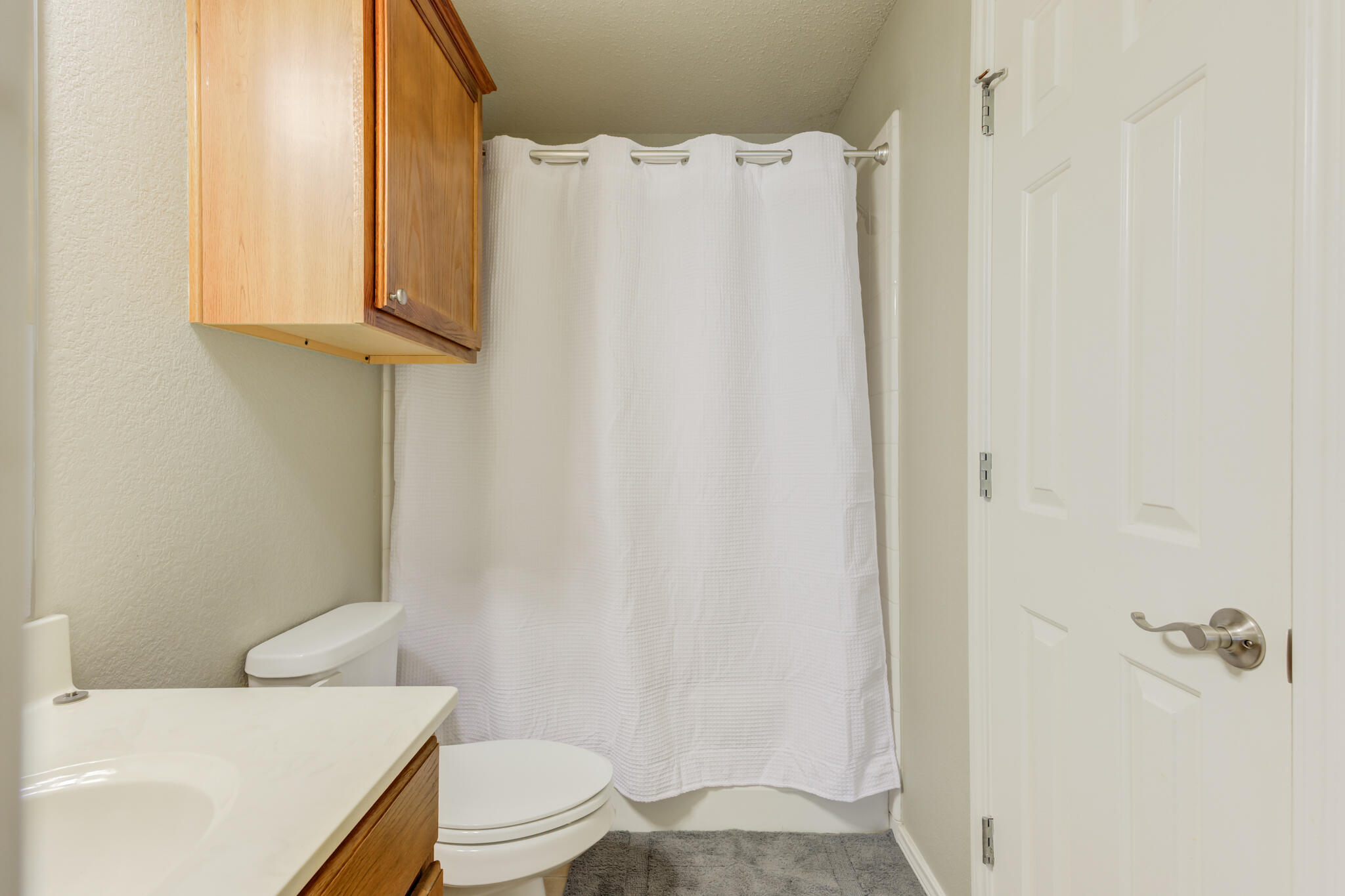 2111 Main Street, Unit 3 Lubbock, TX 79401 - Photo 10 of 49 a white toilet sitting next to a bathroom sink