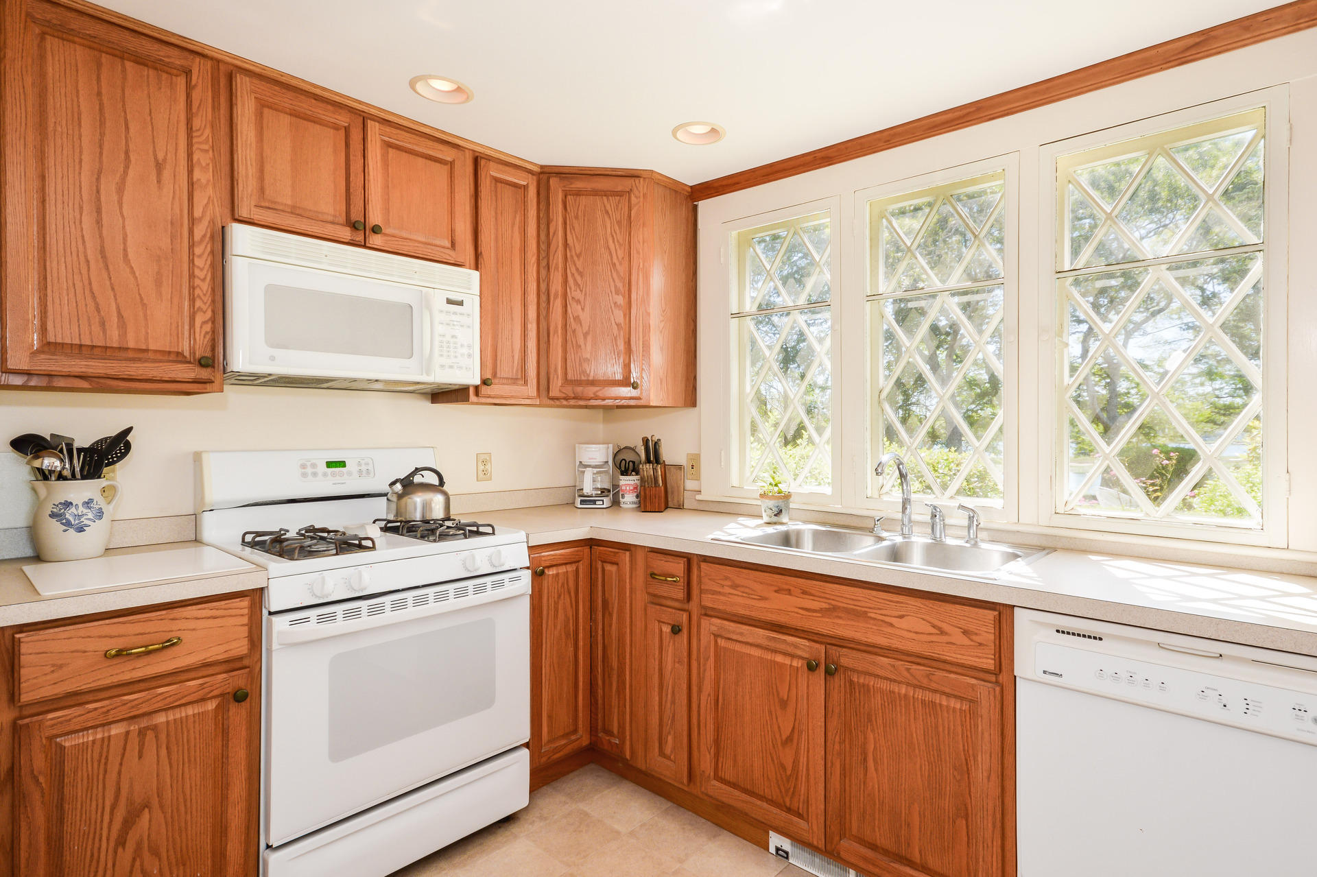 80 Rocky Point Road Bourne, MA 02532 - Photo 13 of 22 a kitchen with stainless steel appliances granite countertop a sink a stove and cabinets