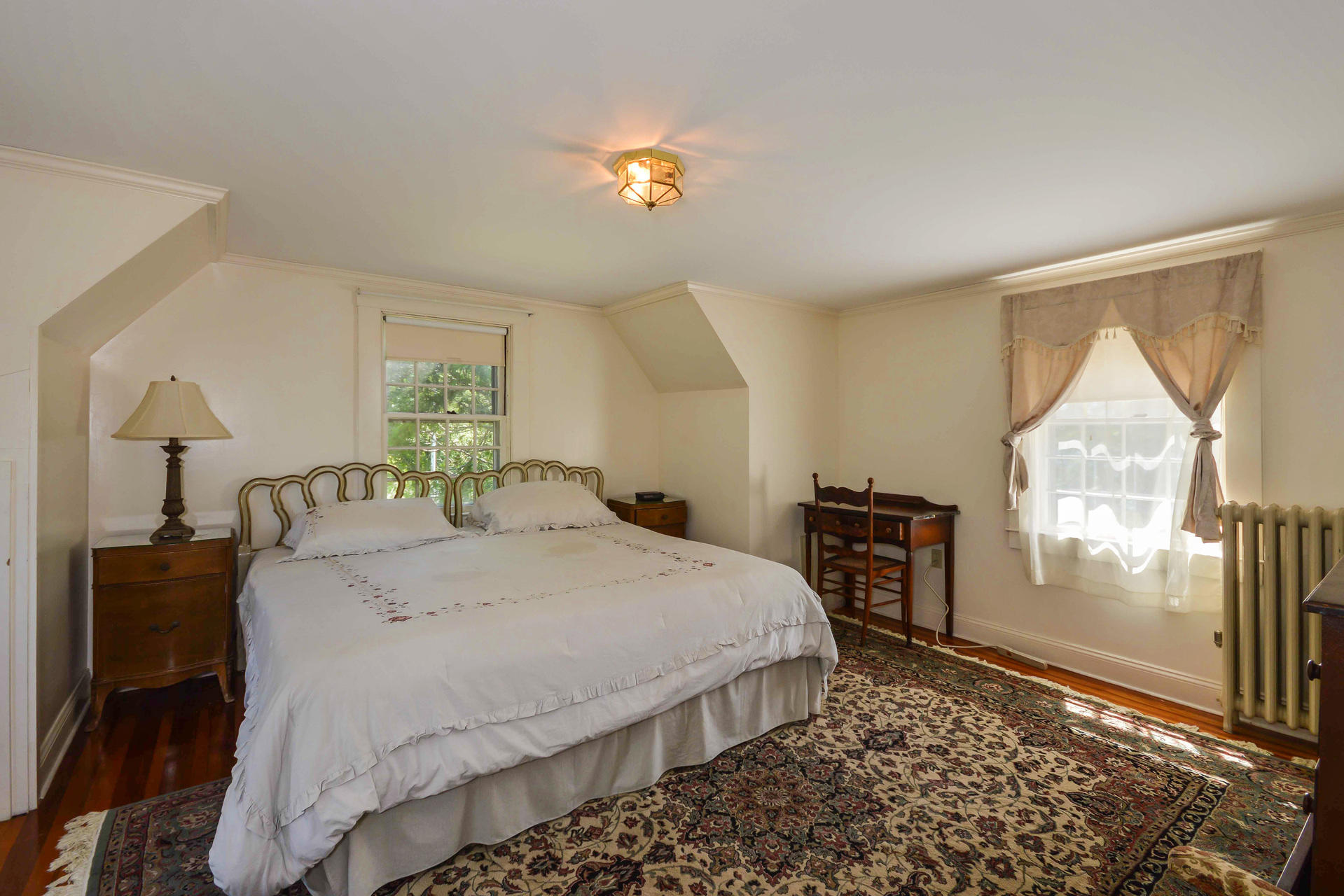80 Rocky Point Road Bourne, MA 02532 - Photo 15 of 22 a bedroom with a bed and a chandelier