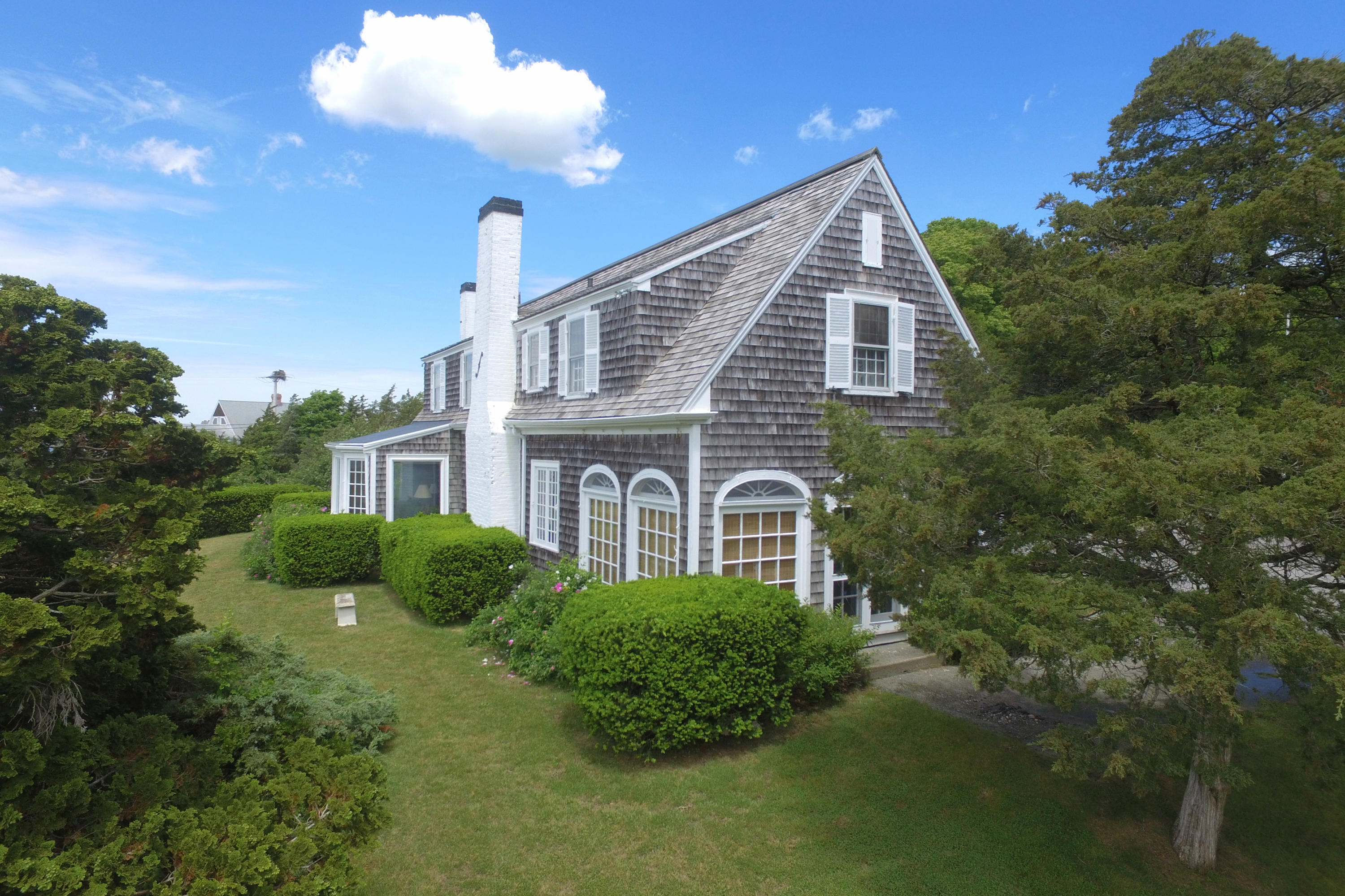 80 Rocky Point Road Bourne, MA 02532 - Photo 7 of 22 a front view of a house with garden