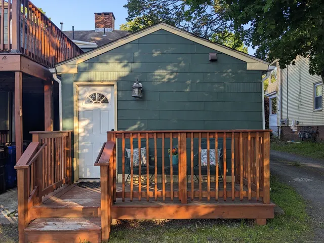 a view of backyard with barbeque grill and wooden fence