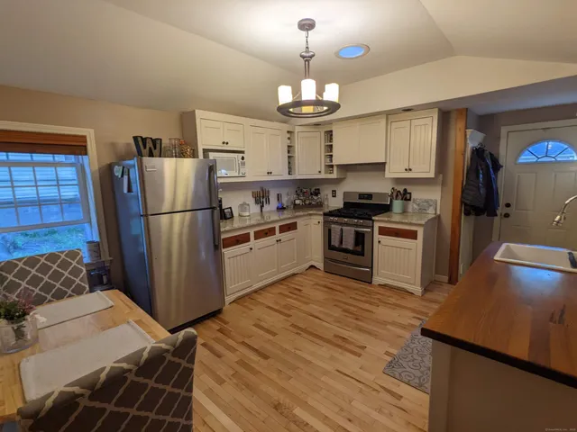 a kitchen with cabinets and stainless steel appliances