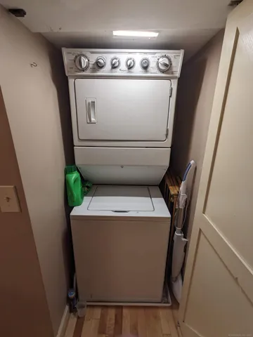 a view of washer and dryer with wooden cabinet