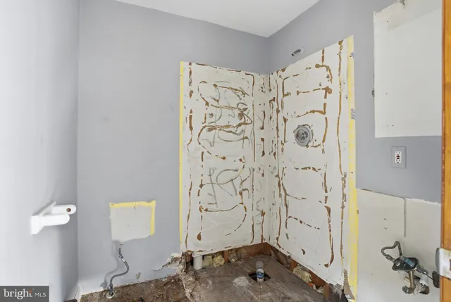 a view of empty room with wooden walls
