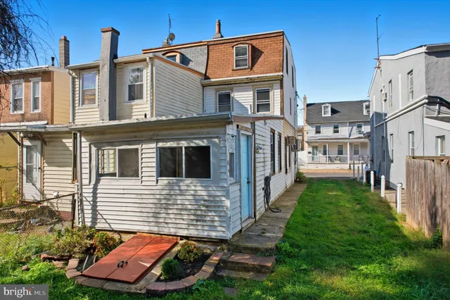 a view of a small house with garage