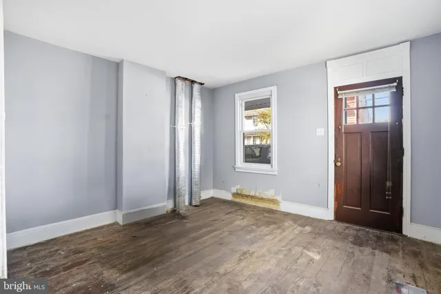 an empty room with windows and closet