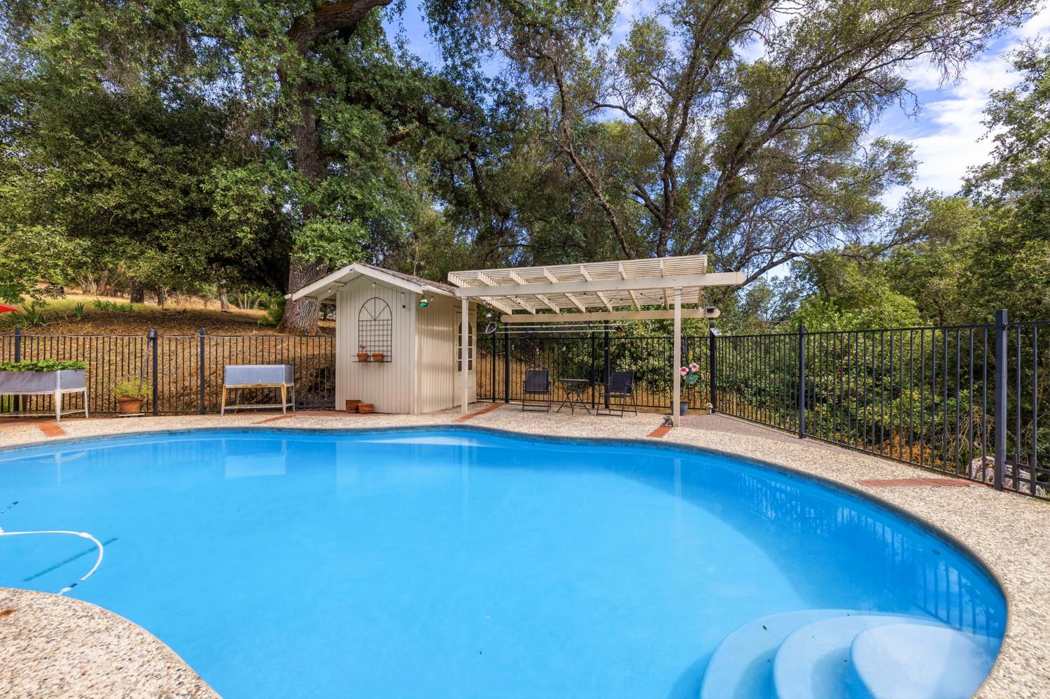 11460 Racetrack Road Sonora, CA 95370 - Photo 39 of 46 a view of a house with pool and sitting area