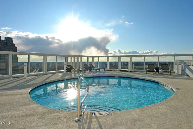 swimming pool view with a seating space