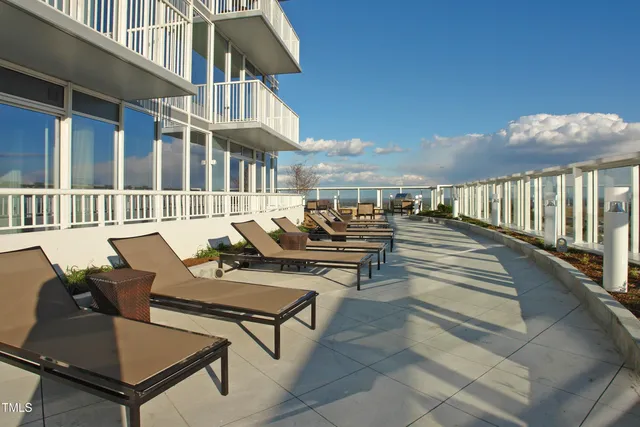 a view of a patio with couches table and chairs and potted plants