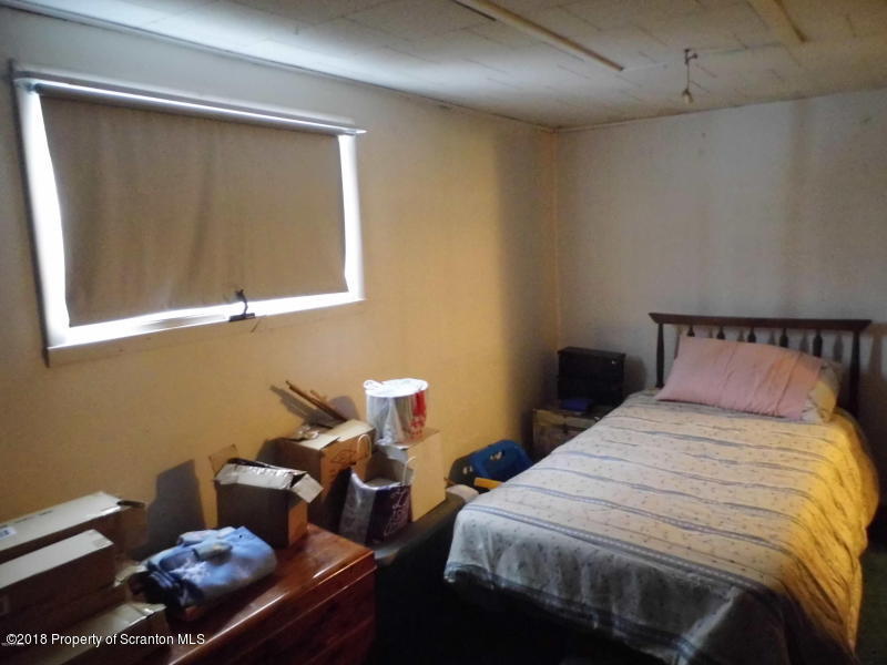 709 Spring Street Moosic, PA 18507 - Photo 11 of 11 a bedroom with bed and a window