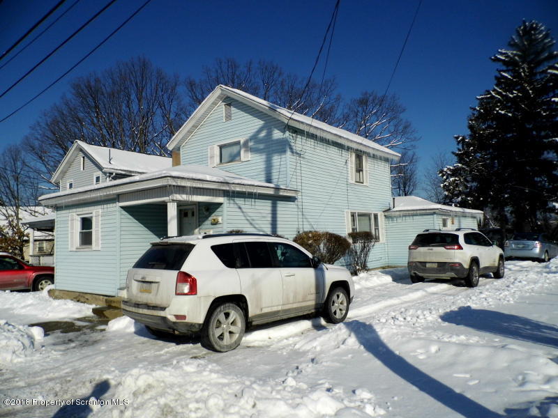 709 Spring Street Moosic, PA 18507 - Photo 3 of 11 a view of a white car parked in front of a house