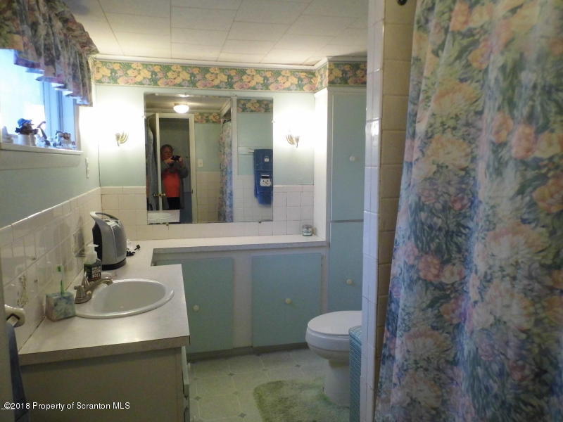 709 Spring Street Moosic, PA 18507 - Photo 5 of 11 a bathroom with a sink toilet and shower