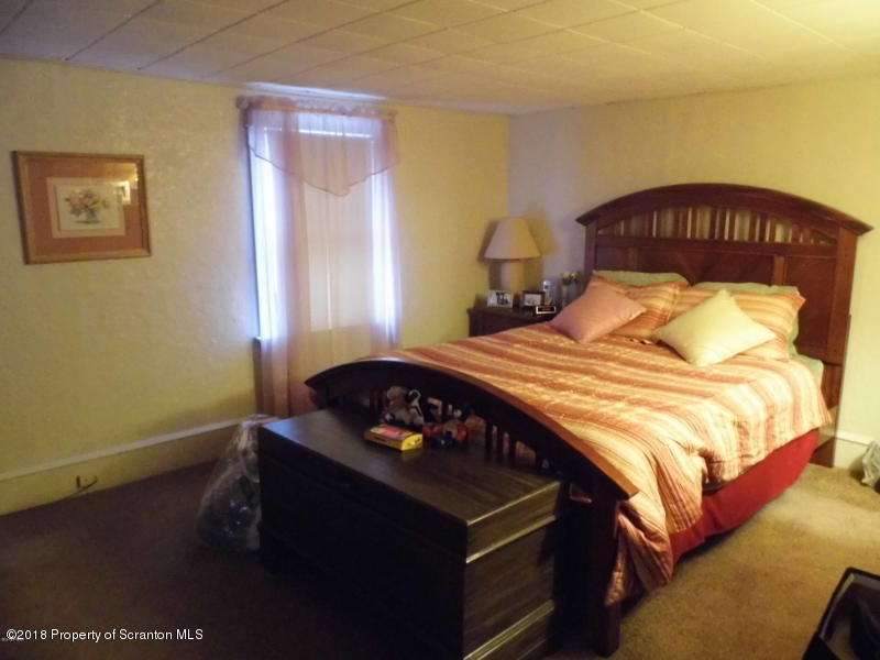 709 Spring Street Moosic, PA 18507 - Photo 8 of 11 a bedroom with a bed and a window