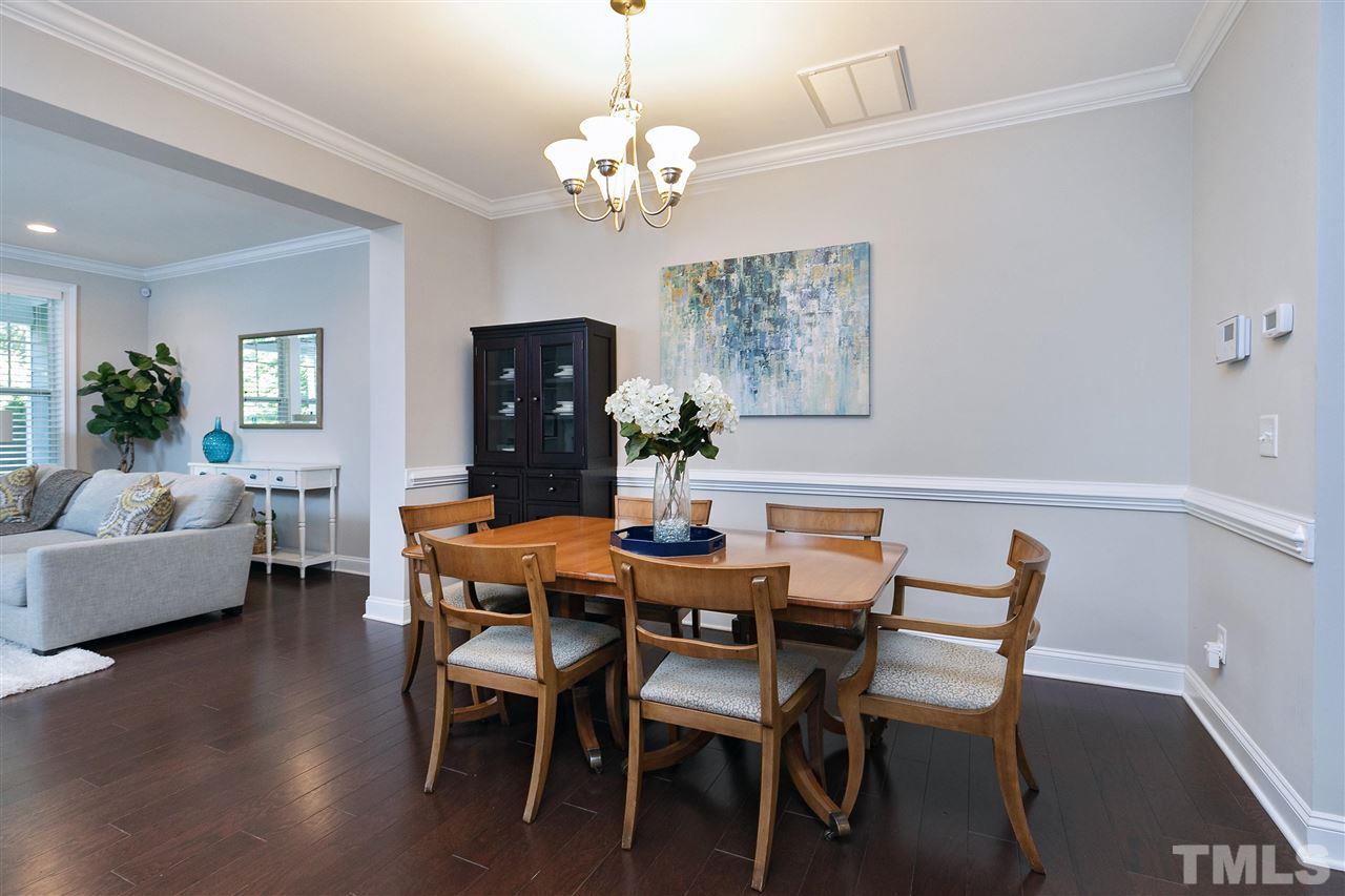 637 Fallon Grove Way Raleigh, NC 27608 - Photo 12 of 30 a view of a dining room with furniture and chandelier