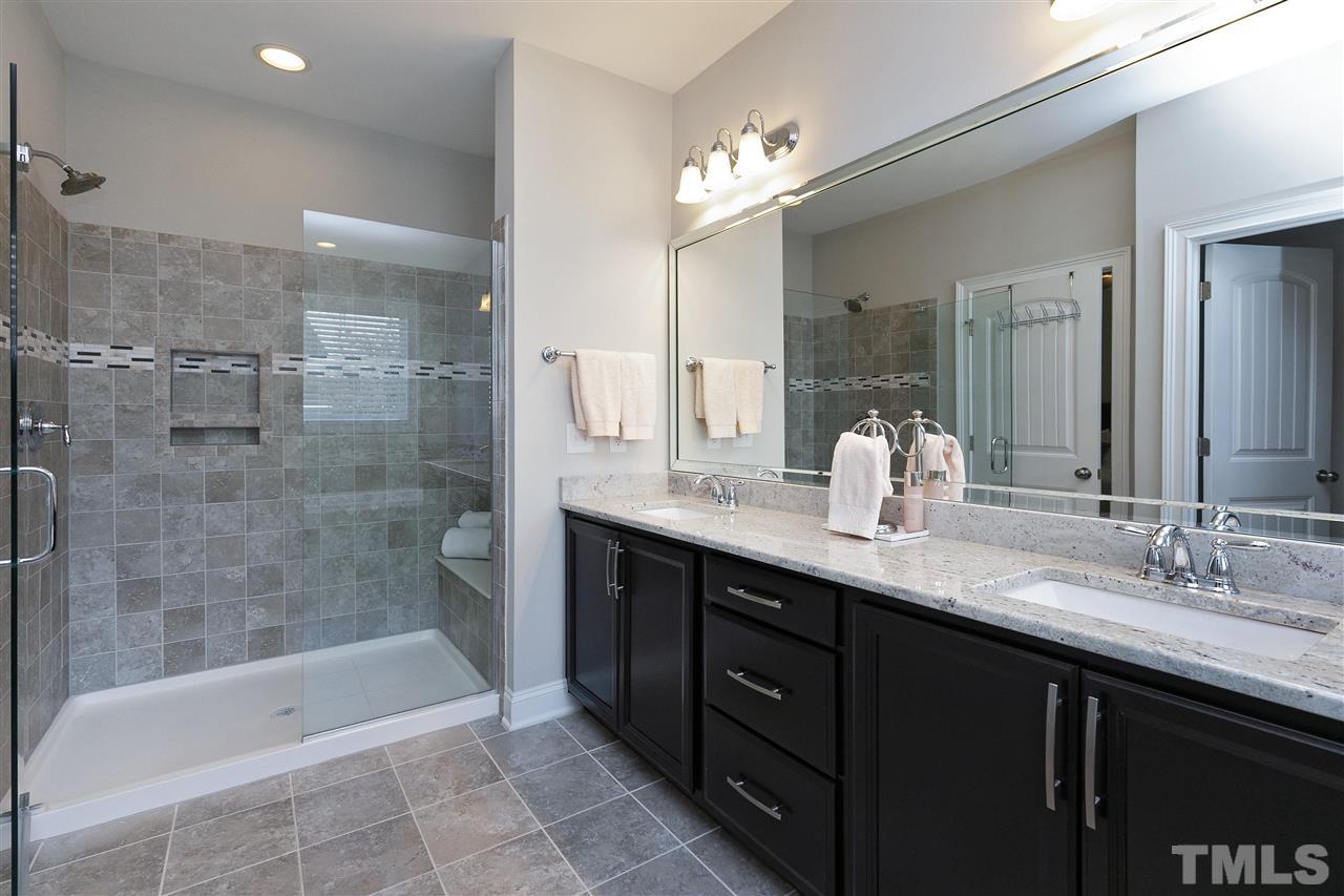 637 Fallon Grove Way Raleigh, NC 27608 - Photo 21 of 30 a bathroom with a bathtub sink double vanity and mirror