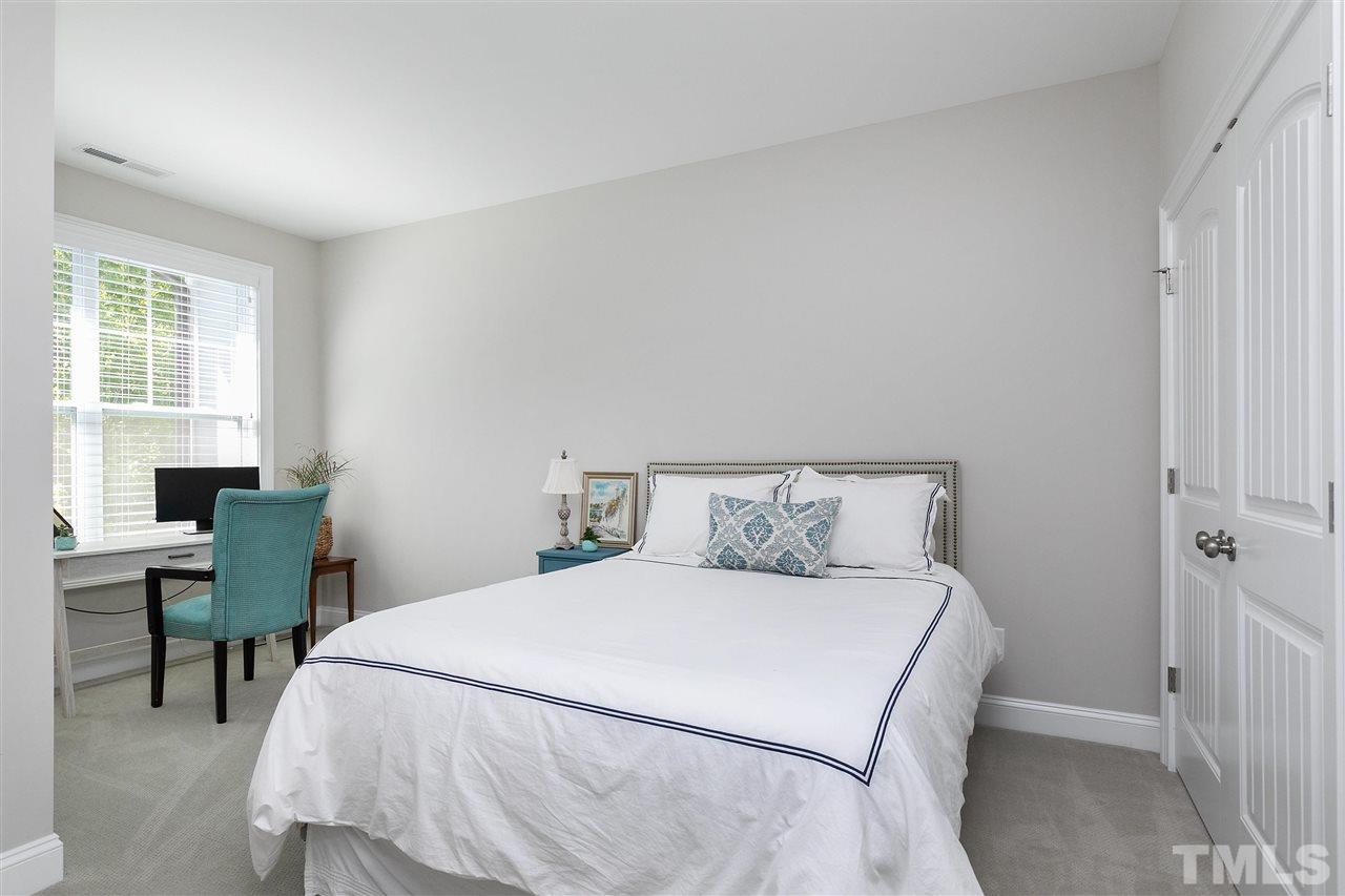 637 Fallon Grove Way Raleigh, NC 27608 - Photo 23 of 30 a bedroom with a bed and a desk