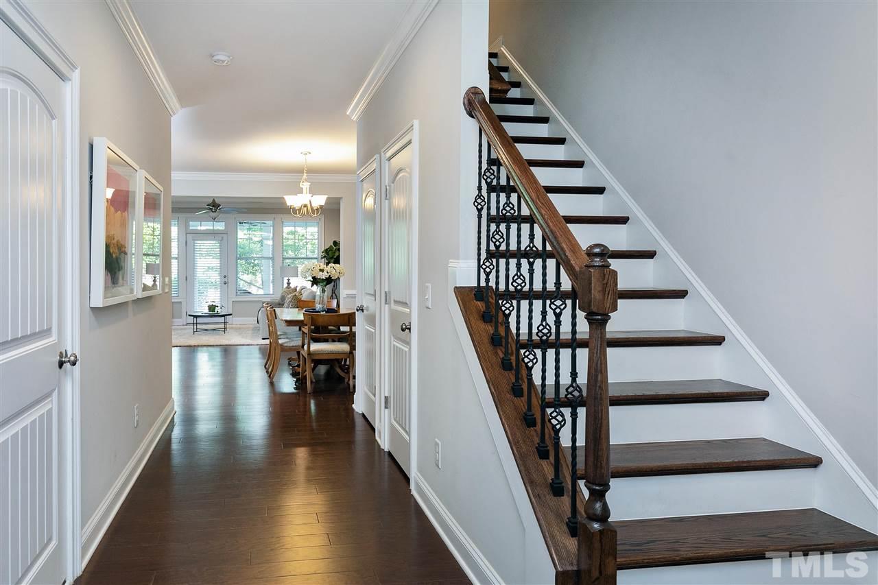 637 Fallon Grove Way Raleigh, NC 27608 - Photo 7 of 30 a view of staircase with lots of frames on wall and wooden floor