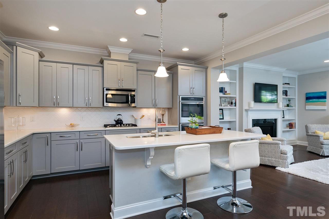 637 Fallon Grove Way Raleigh, NC 27608 - Photo 9 of 30 a kitchen with stainless steel appliances kitchen island granite countertop a sink and cabinets