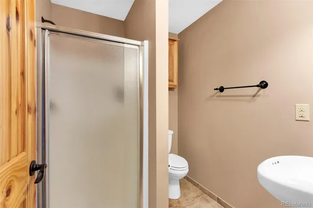 a white toilet sitting next to a bathroom sink