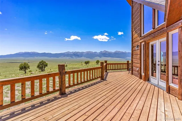 a view of a balcony with wooden floor and city view