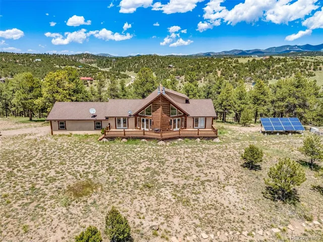 a view of a house with a yard from a balcony