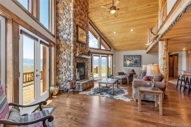 a living room with furniture a window and wooden floor