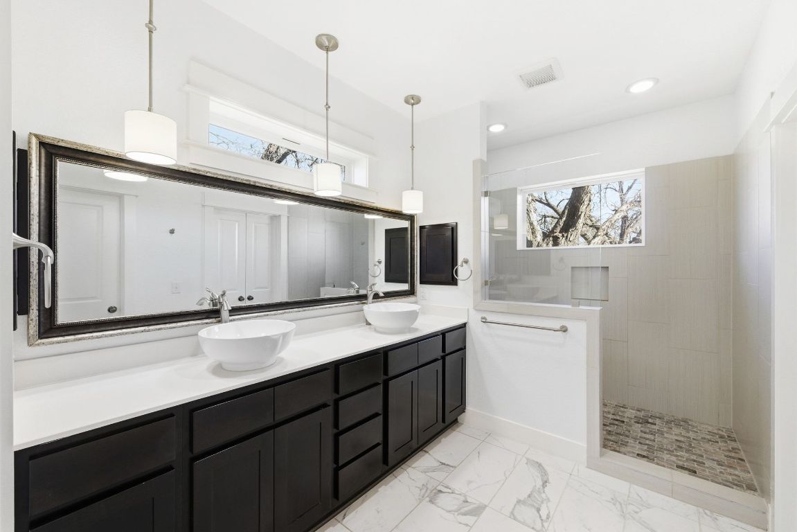 1912 Haskell Street, Unit 1 Austin, TX 78702 - Photo 12 of 23 Bathroom featuring double vanity, walk in shower, and light marble finish flooring