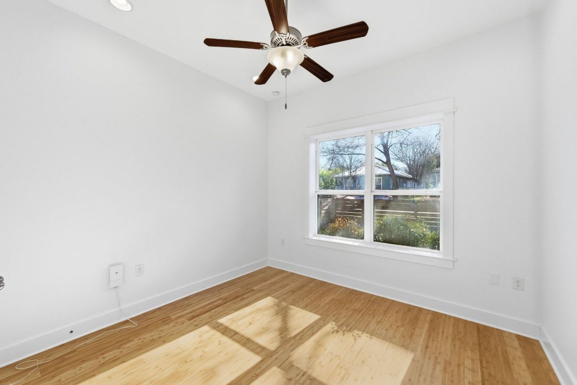 1912 Haskell Street, Unit 1 Austin, TX 78702 - Photo 14 of 23 Empty room with light wood finished floors and a ceiling fan