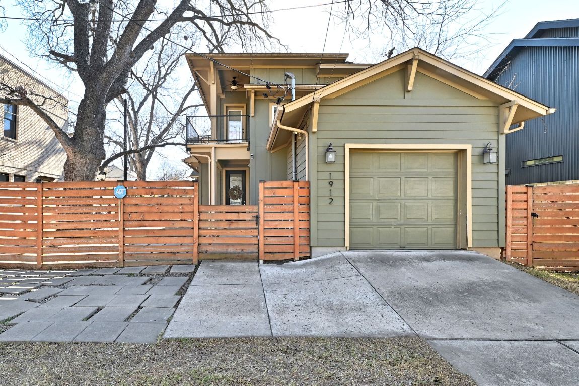 1912 Haskell Street, Unit 1 Austin, TX 78702 - Photo 22 of 23 View of front of home featuring a fenced front yard, a balcony, driveway, and an attached garage