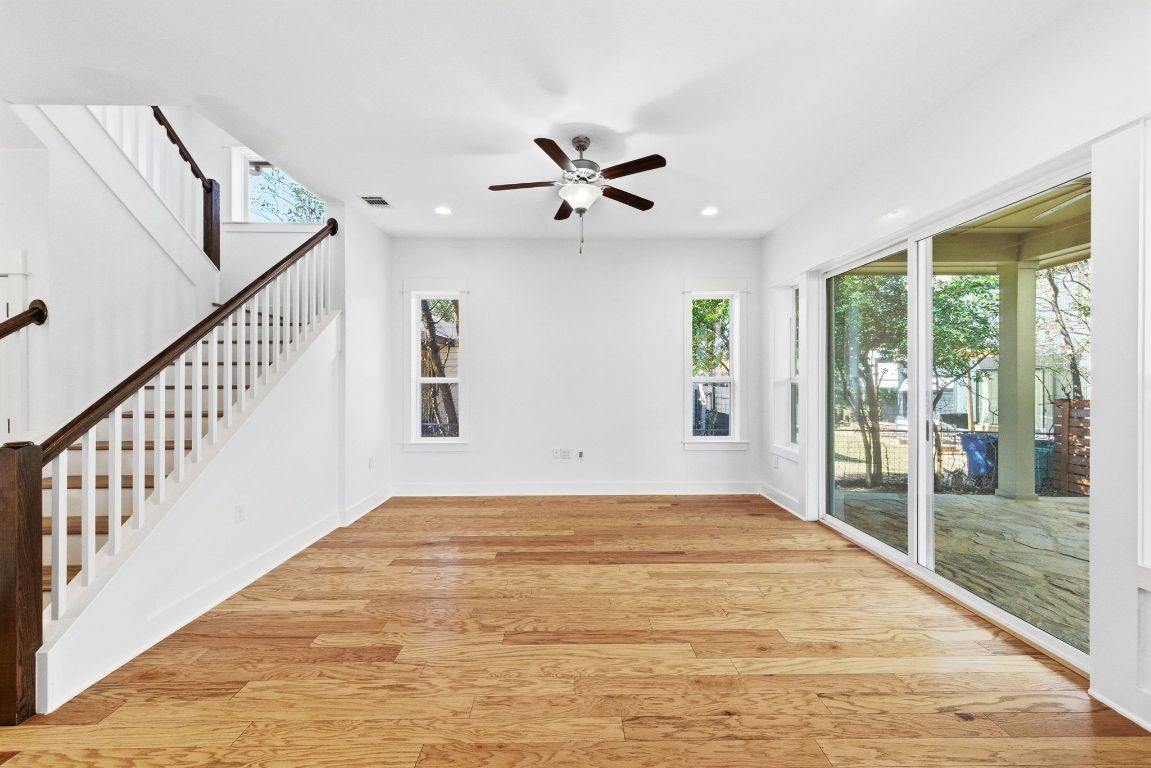 1912 Haskell Street, Unit 1 Austin, TX 78702 - Photo 3 of 23 Spare room with stairway, light wood-style floors, a ceiling fan, and recessed lighting